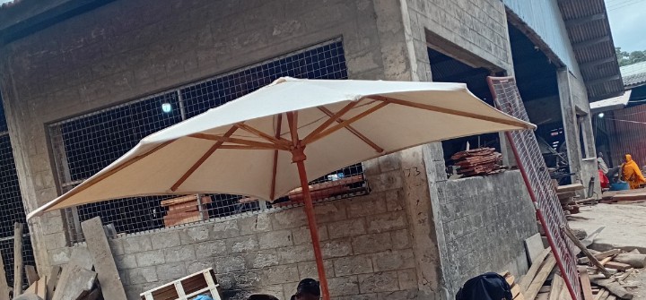 Wooden umbrella with a fabric canopy for an outdoor beach setting in Zanzibar